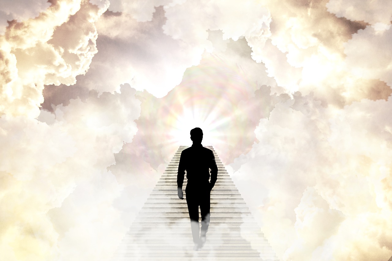 A man walks up stairs into the clouds, or heaven.