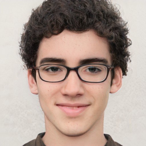 Teen boy with pale olive toned skin, short, dark, curly hair, dark eyes, and glasses